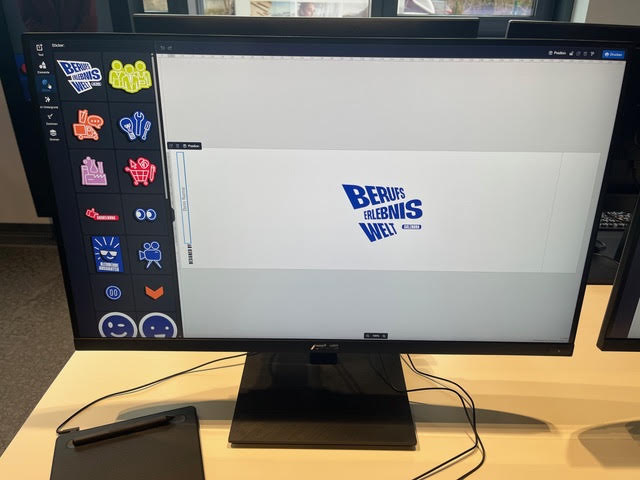 A Polotno workstation at Berufserlebniswelt Salzburg, sticker panel open and the exhibition logo on the canvas